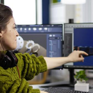 Girl points at computer screen