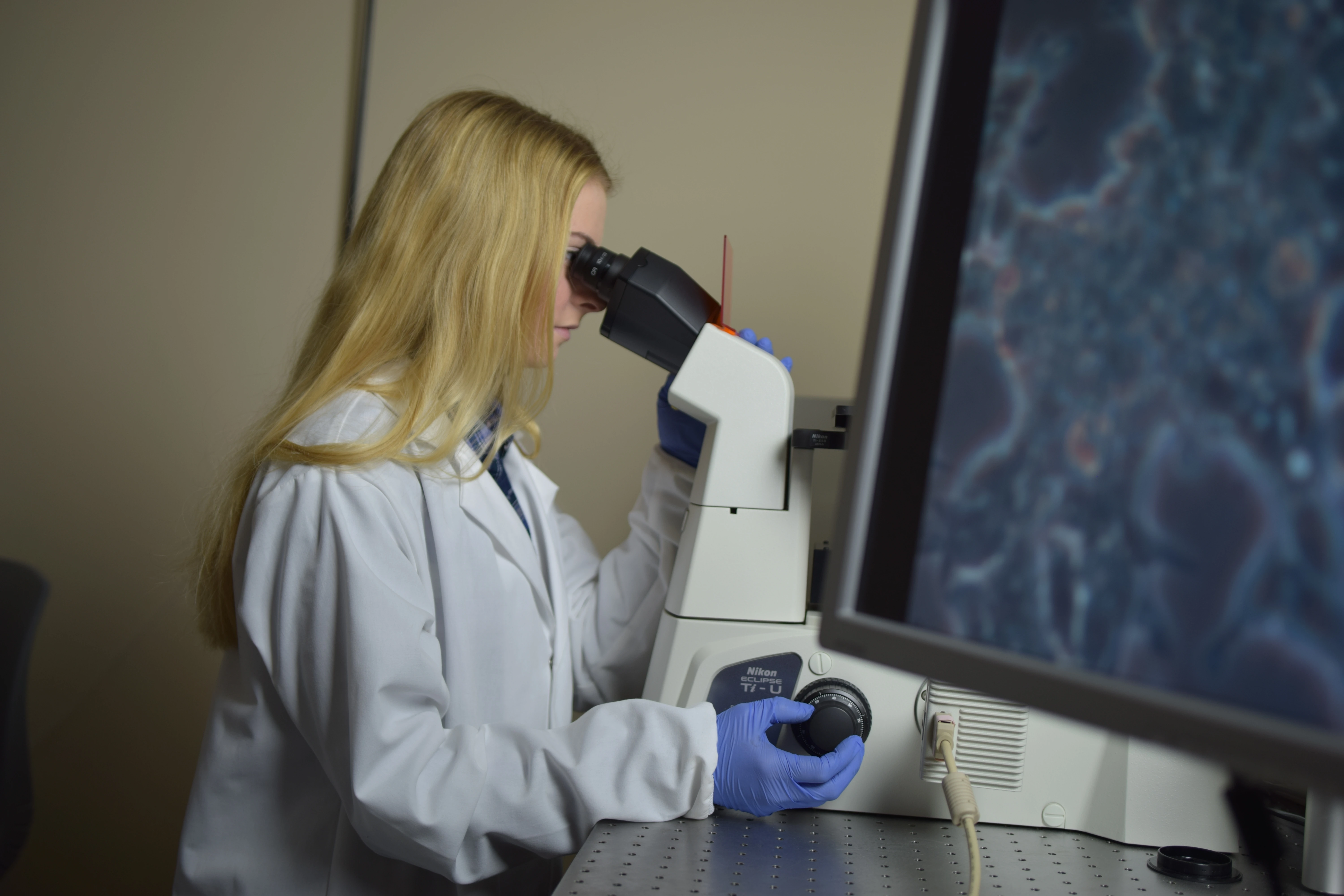 Student Studying Forensic Science With Microscope